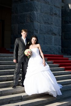 happy newl married couple in the stone staircase