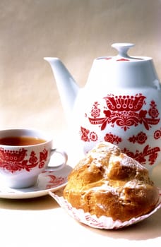 Biscuit, cup of coffee and coffee-pot with red ornament 