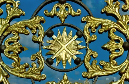 Fragment of figured golden grating with symbol