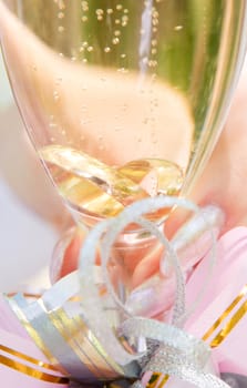 two wedding ring in the glass of champagne