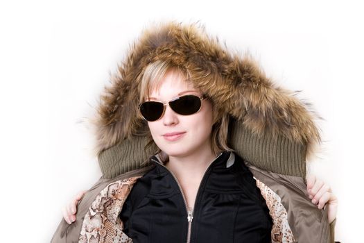 playful girl with sunglasses in a jacket with a collar of fur