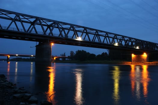 Illuminated railway bridge over the Elbe in Dessau-Ro�lau / Saxony-Anhalt, in the late evening twilight