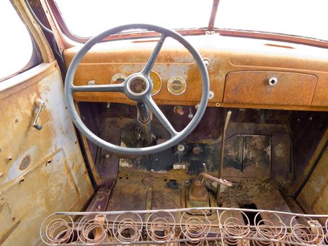 Inside cab view of rusty old junked pick-up truck.
