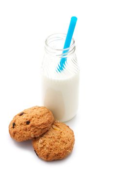 Two oatmeal cookies with peanuts and raisins. Near the glass bottle of milk and cocktail straw. Isolated on white background.