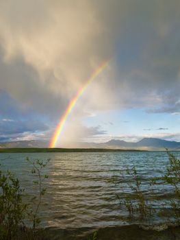 Summer Thundershower resulting in a rainbow over pristine Lake Laberge, Yukon Territory, Canada.