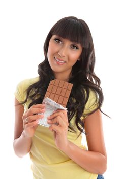 A pretty young woman holding a block of milk chocolate.   She is smiling