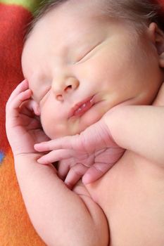 Newborn baby sleeping on a soft blanket