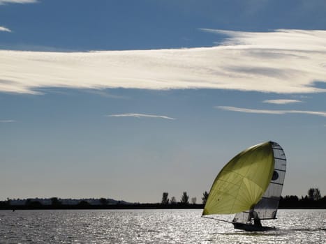 A boat sailing under a cloudy sky