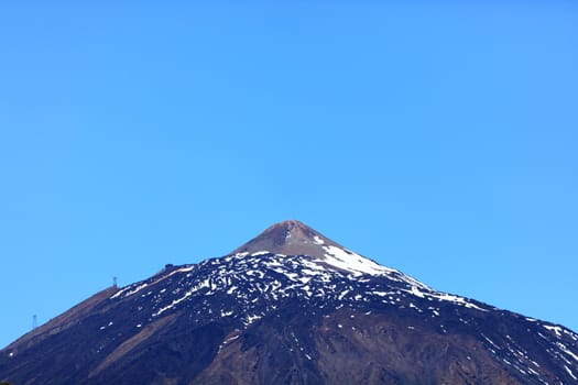 Teide mountain top. Pico del Teide - partly snow covered volcano peak photo from Tenerife during spring.