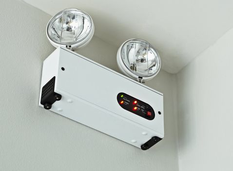 A device for alarm mounted on the wall in the room
