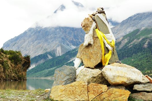 Landscape of prayer rocks at the lakeside in Tibet
