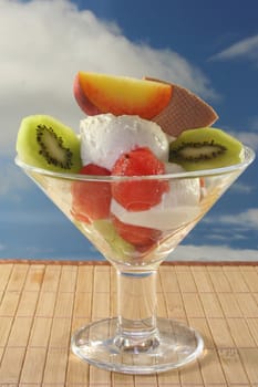 Fruit sundae with fresh kiwi, peach and melon