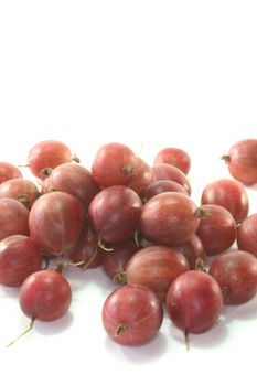 some red gooseberries on a white background