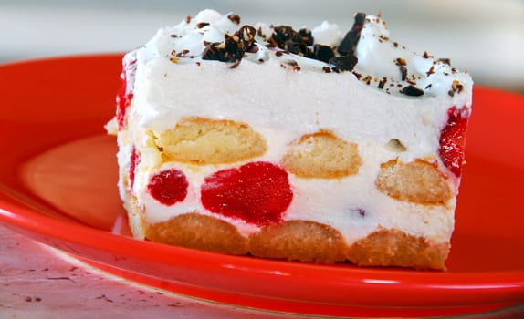 piece of white creamy strawberry cookie on red plate