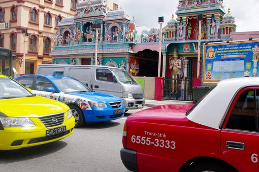 Cars and taxis fill the streets during rush hour, infront of Sri Vadpathira Kaliamman temple, Serangoon rd. Singapore.