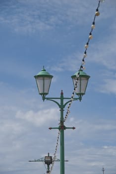 Vintage former Gas Lighting on a seaside pier under a summer sky
