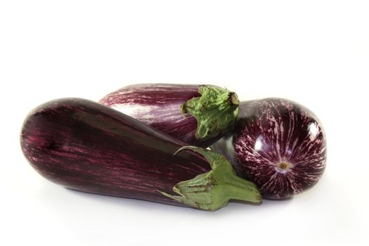 three eggplants on a white background