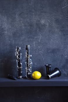 black still-life with lemon and vintage musical instrument