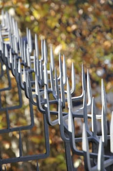 Metal spikes with autumn glowed background