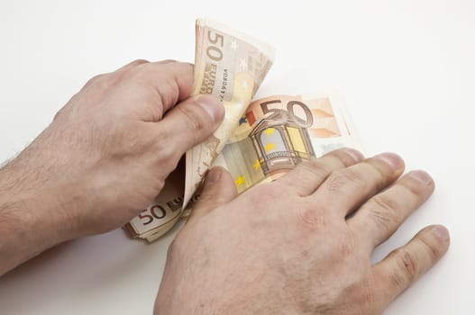 Two hands counting wad of fifty Euro banknotes