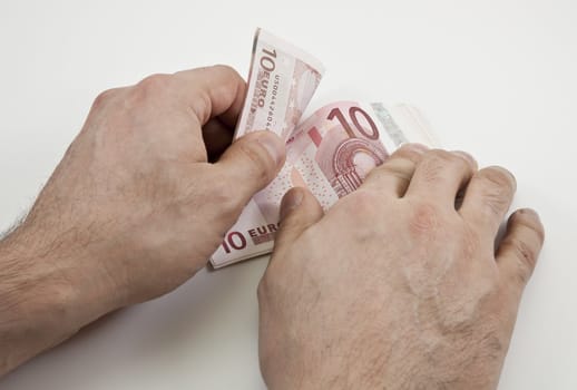 Two hands counting wad of ten Euro banknotes