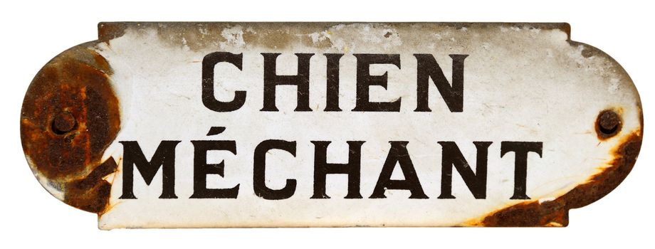 An old, chipped 'Beware of the Dog' sign in French
