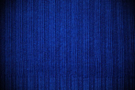 Background a texture a knitted fabric "elastic band" of dark blue color