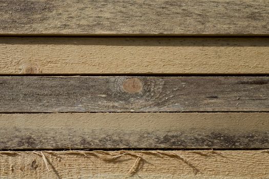 Stack of Building Lumber at Construction Site. Close up view of stacked wooden boards 
