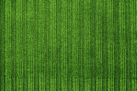 Background a texture a knitted fabric "elastic band" of green color.