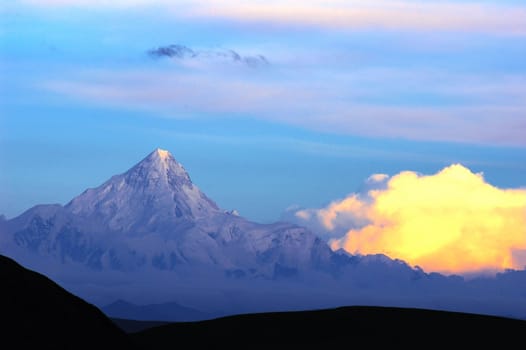 Landscape of snow-capped mountains of Gongga in Sichuan, China at sunset