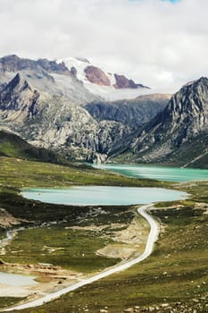 Landscape of snow-capped mountains and blue lake 