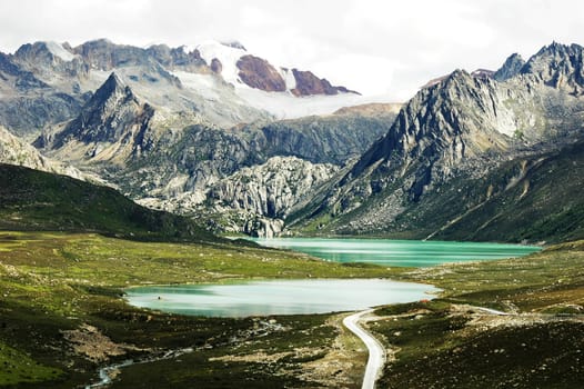 Landscape of snow-capped mountains and blue lake 