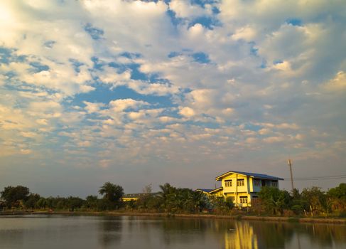 House beside the fish pond at the evening.