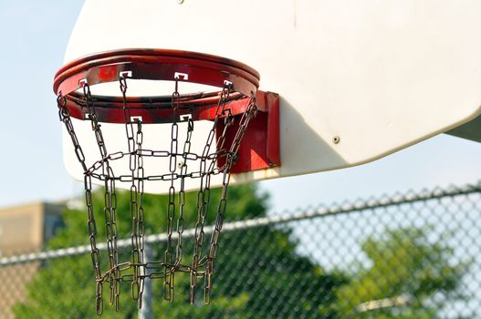 Old rusted chain link basketball basket of an inner city with copy space on the white board.