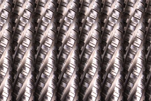 A background of metallic rods/broaches with a pattern.