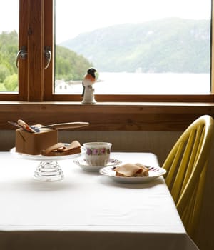 Breakfast table with coffee and wholegrain bread with brown cheese