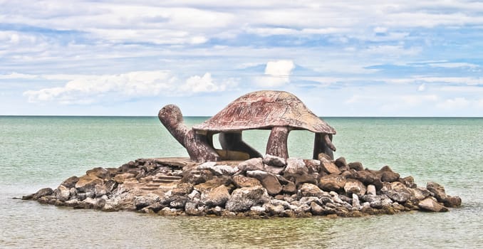 Turtle statues in the sea.