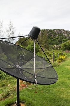 Satellite dish in morning sky.