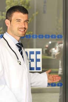 portrait of doctor in front an entrance of the hospital