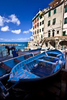 Fisherman village  Riomaggiore is one of five famous colorful villages of Cinque Terre in Italy, suspended between sea and land on sheer cliffs upon the  turquoise sea.