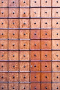 Repeated square pattern on an old wooden church door.