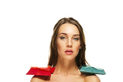 beautiful woman with red and green presents on her shoulders on white background