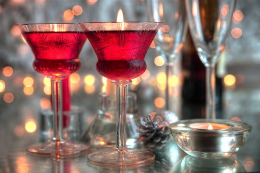 Red wine in glasses,candle on silver background