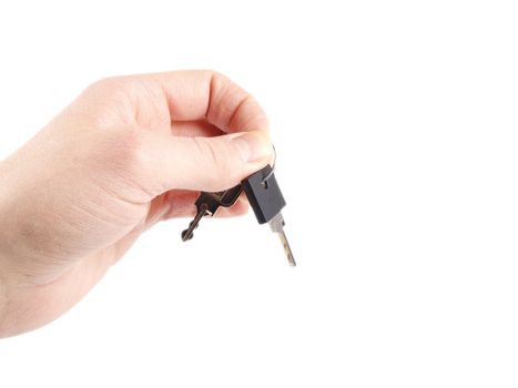 Someone holding a pair of keys, towards white