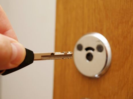 Someone approaching a wooden door, with a key in hand