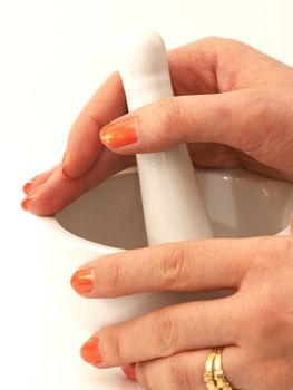 Women with orange manicure, using a mortar, isolated towards white background