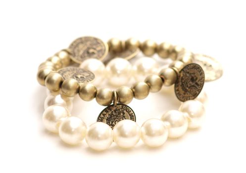 White and golden pearls with pennies, on white background 