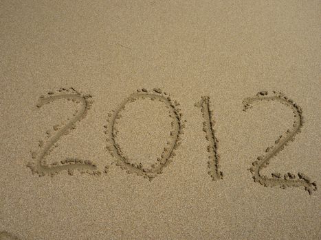 new 2012 year numbers drawings in the sand on the beach