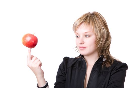 girl holds an apple on a finger