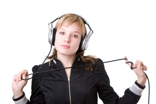 a girl plays with a cable of the earphones listening to the music